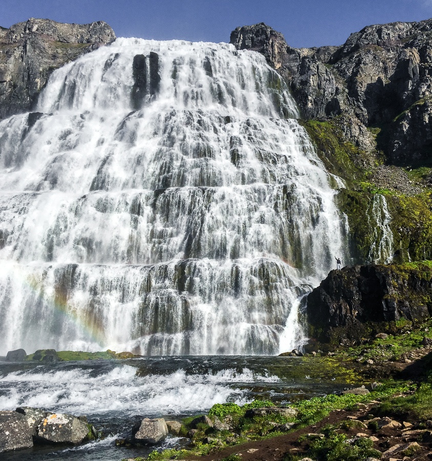 Tiny travel guy at Dynjandi Waterfall in Iceland